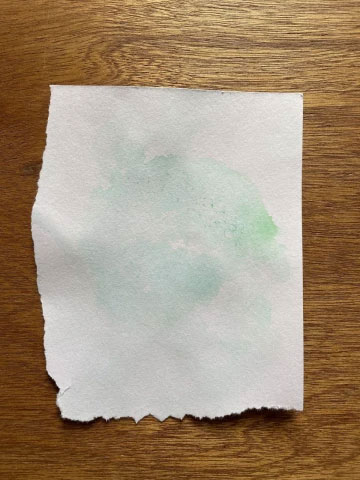 Paper dyed in a green pattern using bubbles