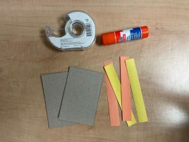 Photo showing two rectangles and four strips of paper.